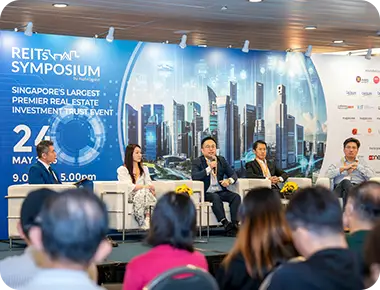 Attendees networking at REITs Symposium conference